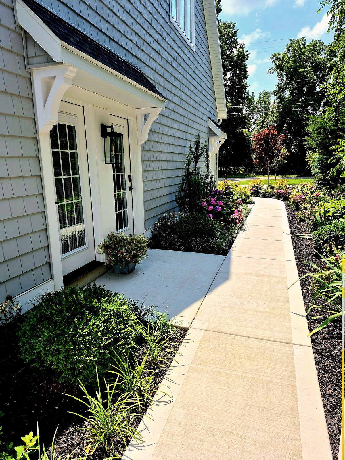 Private suite entrances and paved garden walkway